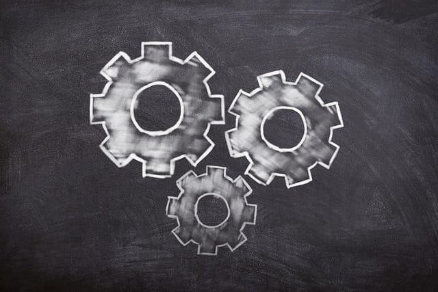 Chalk drawing of gears on a blackboard